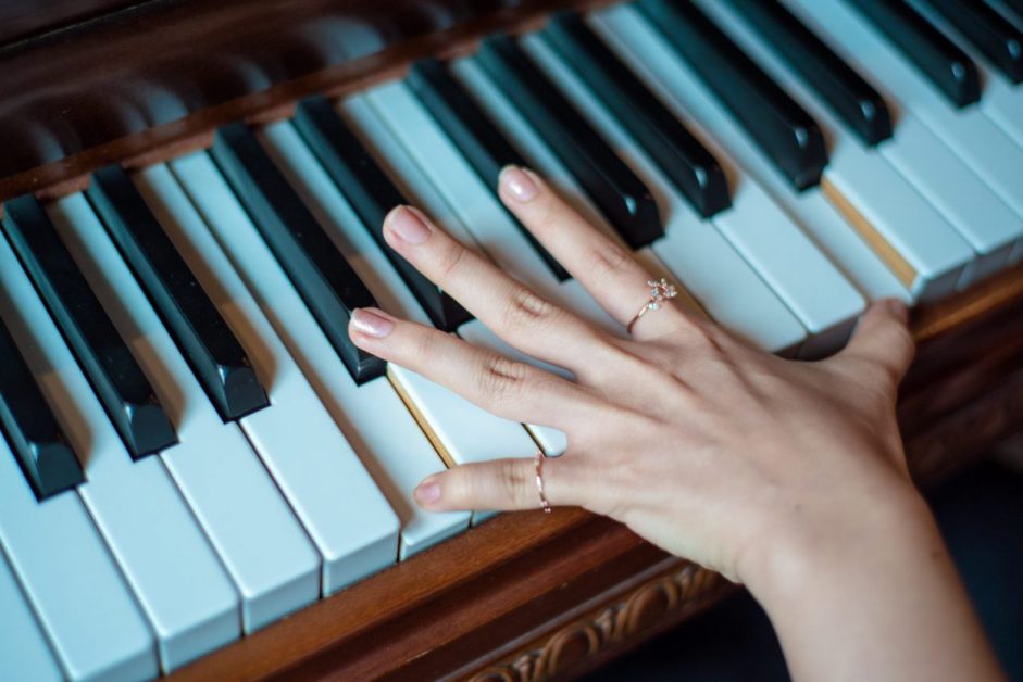 young female hand on piano keys