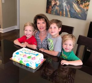 lady with grandkids and birthday cake