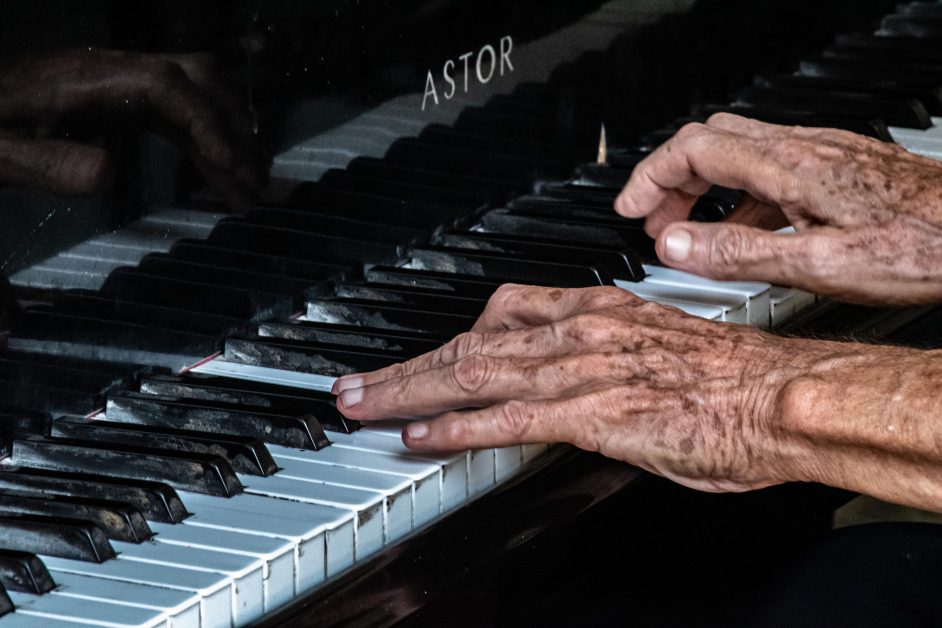 old person playing piano