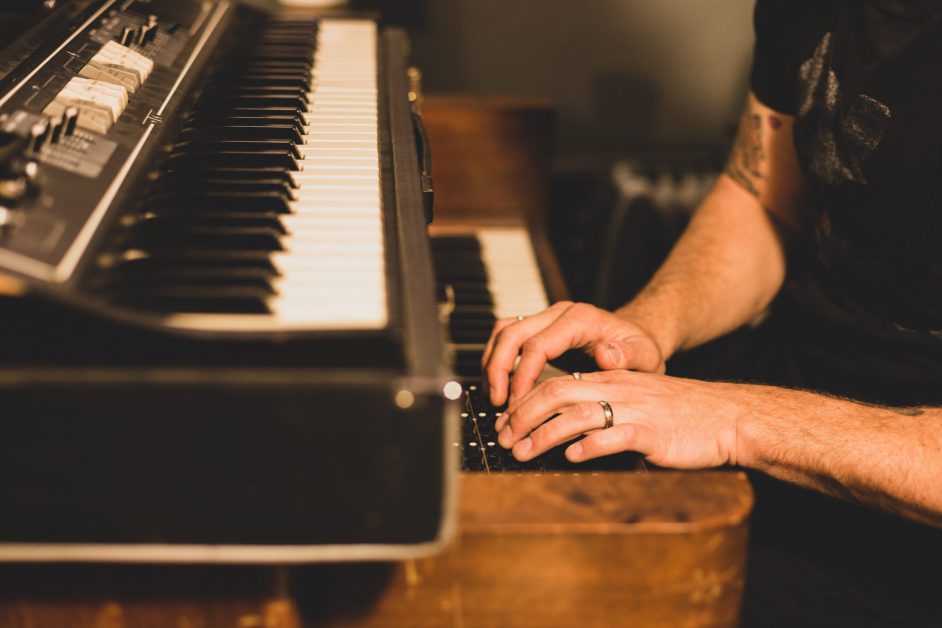 man sitting at piano playing