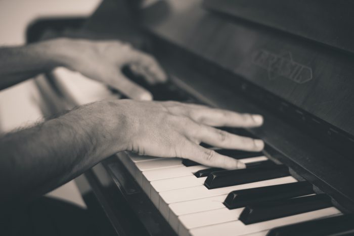 man playing Brasil piano